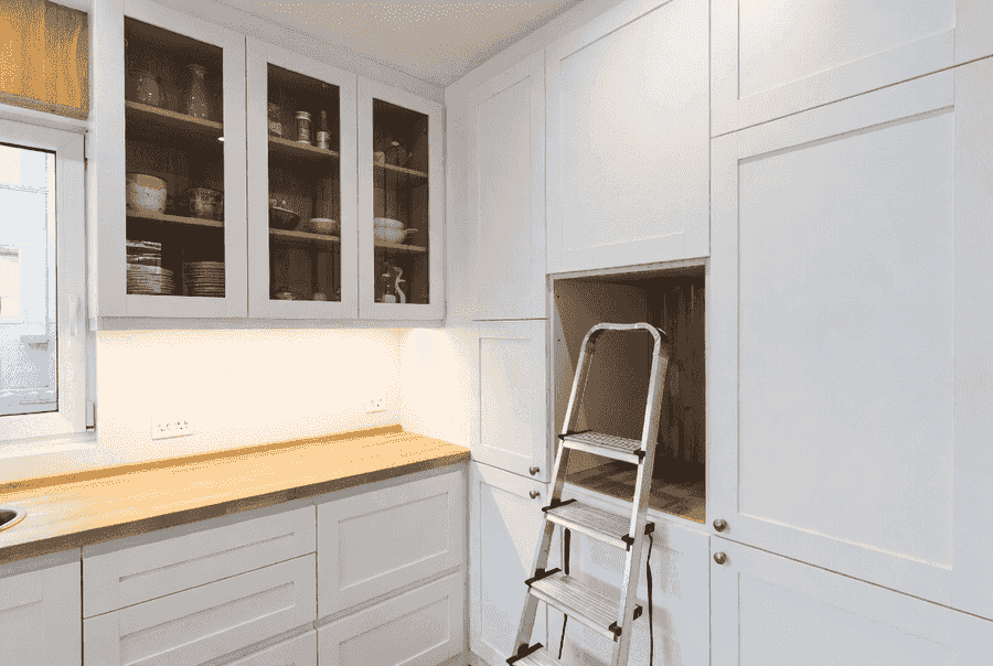 Floor-to-ceiling cabinetry maximizing vertical space in a small kitchen